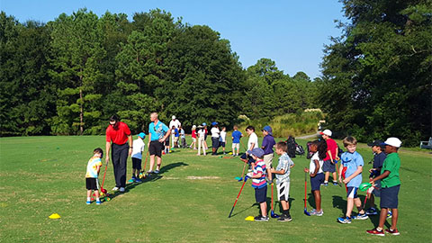First Tee of the Lowcountry. group of kids and adults on a golf course