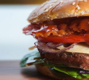 best burgers in bluffton. a hamburger with cheese, onions, bacon