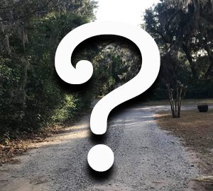 Discover the Curious Codes and Quirky Characteristics of Bluffton. A question mark on a photo of a dirt road