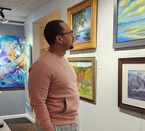 Society of Bluffton Artists Judged Show. A man looking at artwork