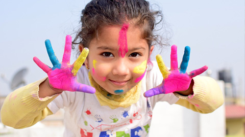 Kids' Camps in Bluffton, SC, Summer 2025. A little girl with paint on her hands and face