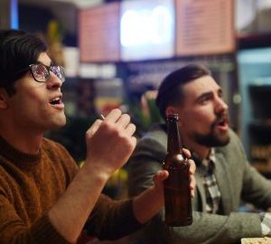 Best Places to Watch Football in Bluffton. two guys at a bar with beers