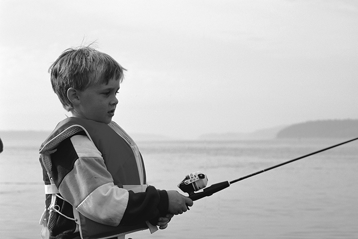 A Fishing Lesson little boy in life preserver fishing